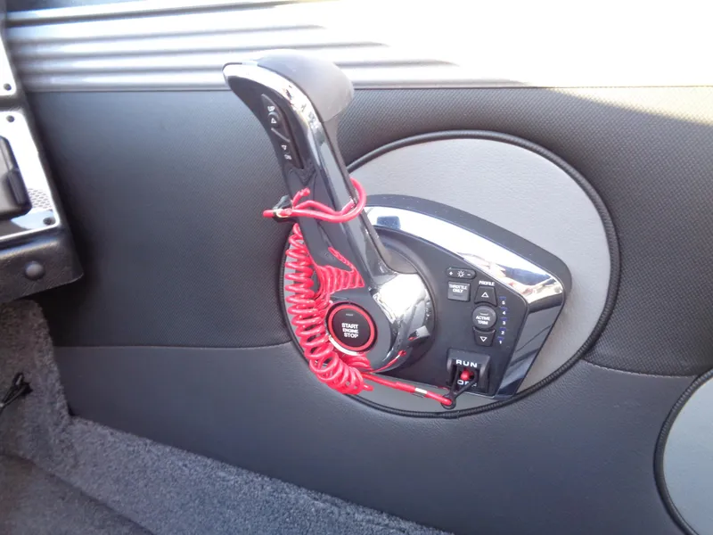 Slide: The Image of Control panel of 2025 Lund 1875 Tyee boat with throttle and start button. - 12