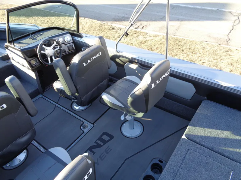 Slide: The Image of 2025 Lund 1875 Tyee boat interior with seating and steering console. - 13