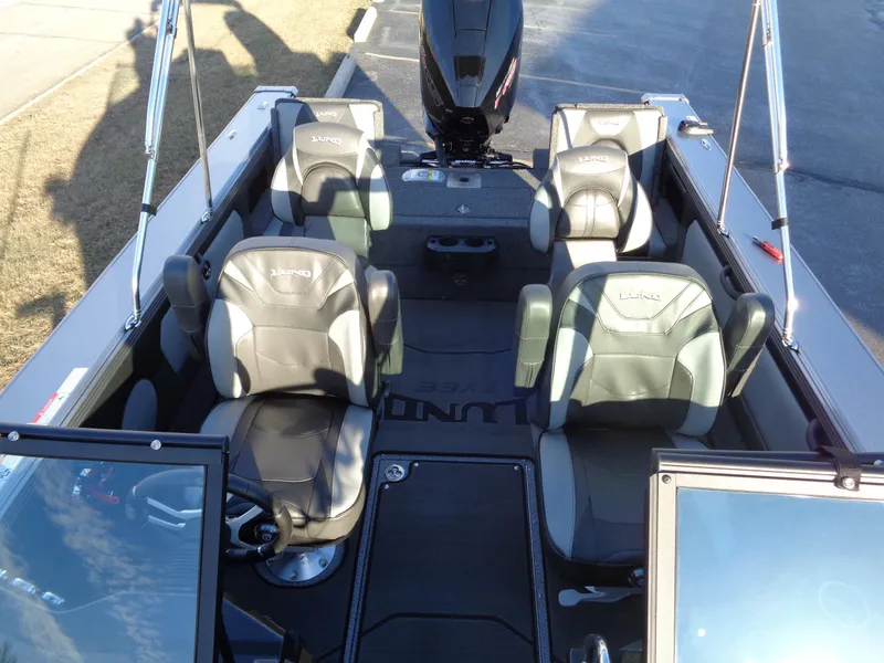 Slide: The Image of 2025 Lund 1875 Tyee boat interior with four cushioned seats and motor. - 16