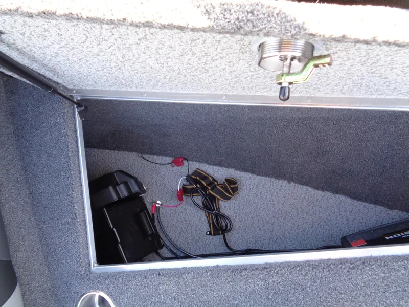 Slide: The Image of Storage compartment in 2025 Lund 1875 Tyee boat, featuring battery and wiring. - 19