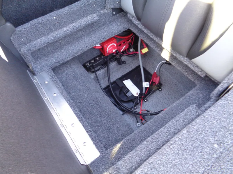 Slide: The Image of 2025 Lund 1875 Tyee boat interior storage compartment with wiring and components. - 20