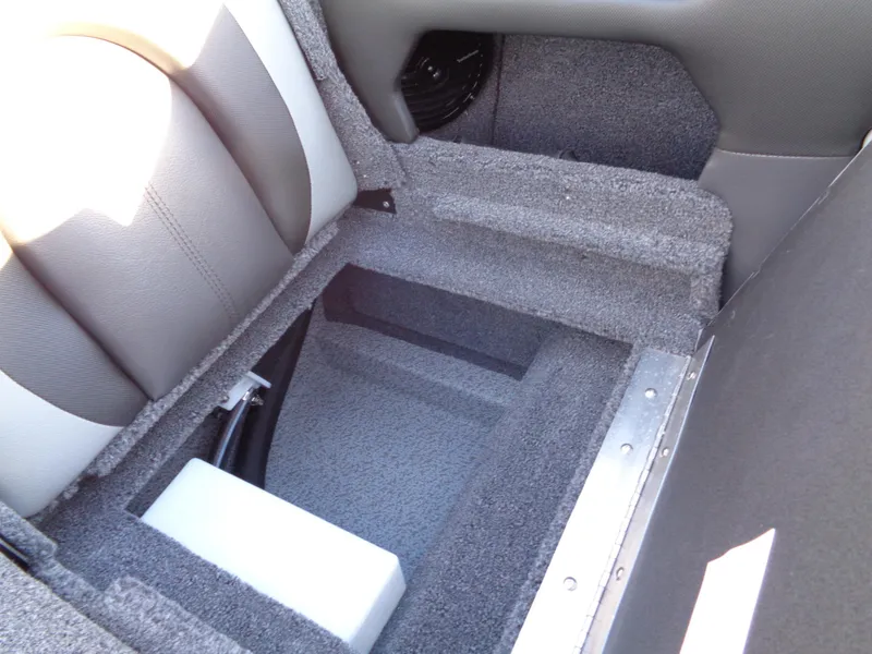 Slide: The Image of 2025 Lund 1875 Tyee boat interior storage compartment with gray upholstery and carpeted finish. - 21