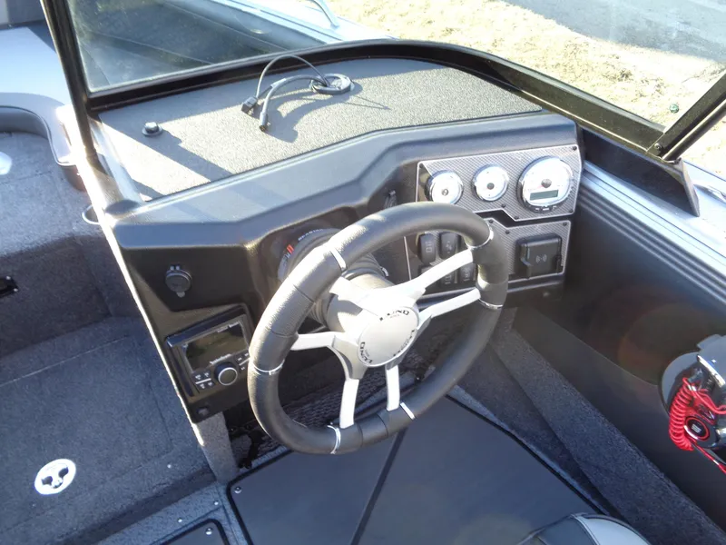 Slide: The Image of 2025 Lund 1875 Tyee boat dashboard with steering wheel and instrument panel. - 25