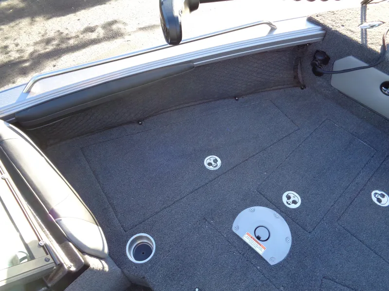 Slide: The Image of Interior view of 2025 Lund 1875 Tyee boat, featuring carpeted flooring and seating. - 27