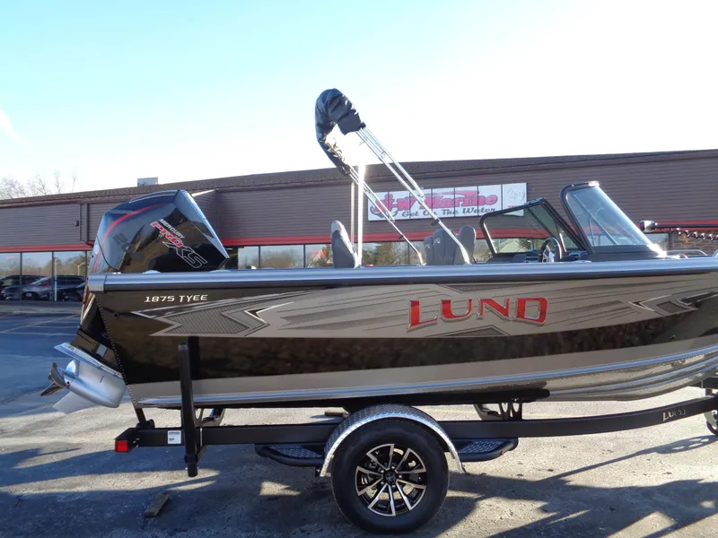 Slide: The Image of 2025 Lund 1875 Tyee boat on trailer, side view, outdoors. - 4