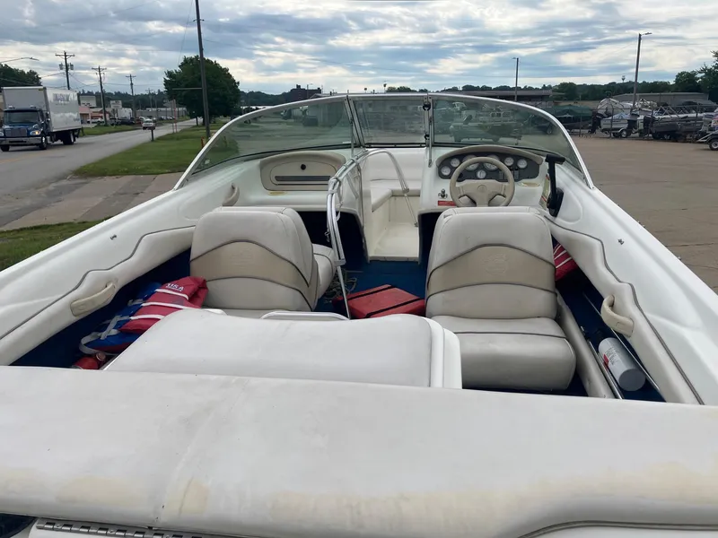 Slide: The Image of 1996 Sea Ray 175 Open Bow boat interior with white seating and steering wheel. - 8
