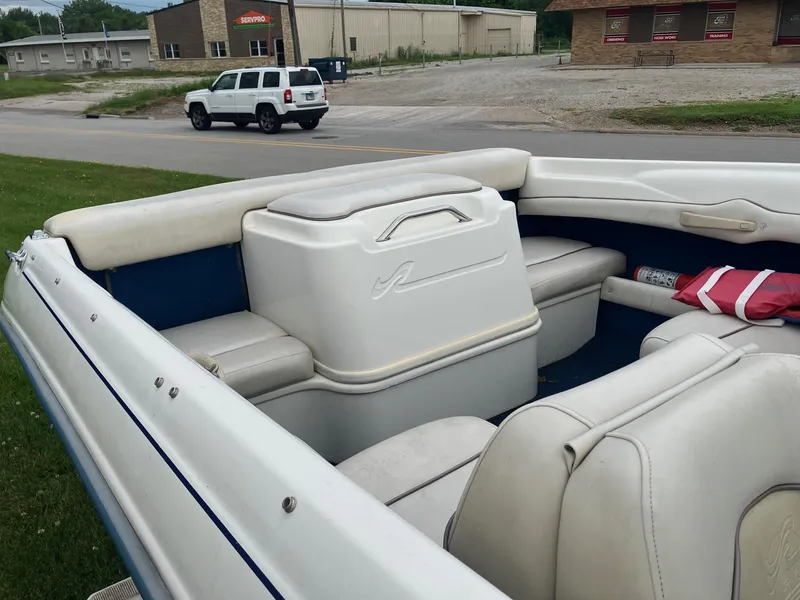 Slide: The Image of 1996 Sea Ray 175 Open Bow boat interior with white seating and storage compartments. - 9