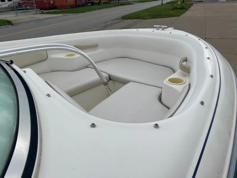 Slide: The Image of 1996 Sea Ray 175 Open Bow boat interior with white seating and cup holders. - 10