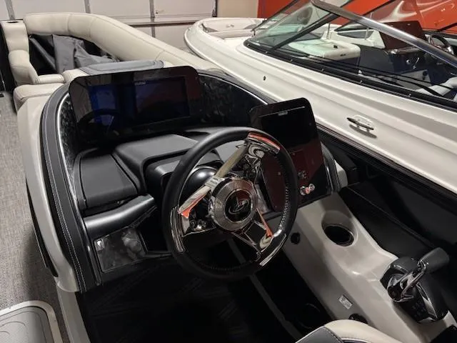 Slide: The Image of 2026 Barletta L25MA boat interior with modern steering and digital displays. - 10