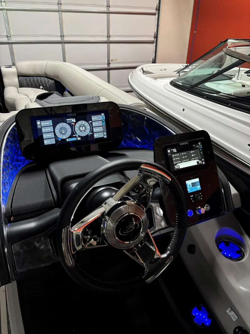 Slide: The Image of 2026 Barletta L25MA boat dashboard with advanced digital displays and illuminated controls. - 13