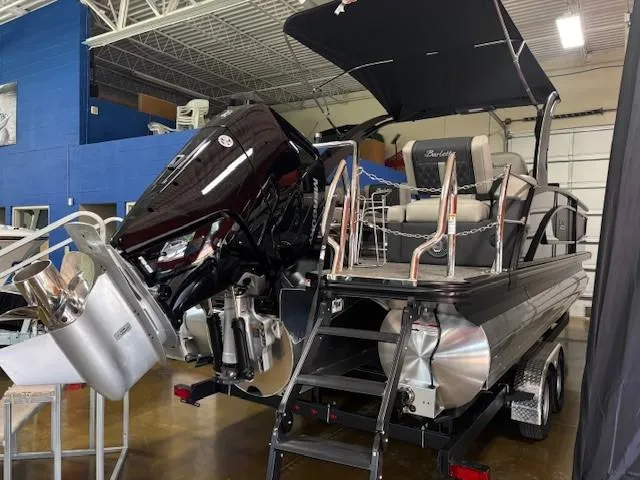Slide: The Image of 2026 Barletta L25MA pontoon boat with outboard motor in showroom. - 14