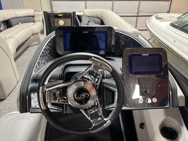 Slide: The Image of 2026 Barletta L25MA boat dashboard with steering wheel and digital displays. - 9