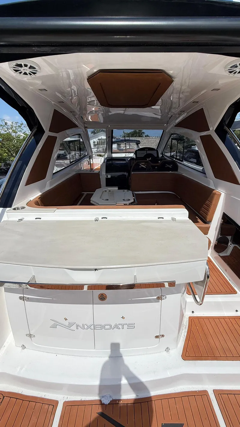 Slide: The Image of 2025 NX Boats NX370 HT interior with sleek design and modern amenities. - 5
