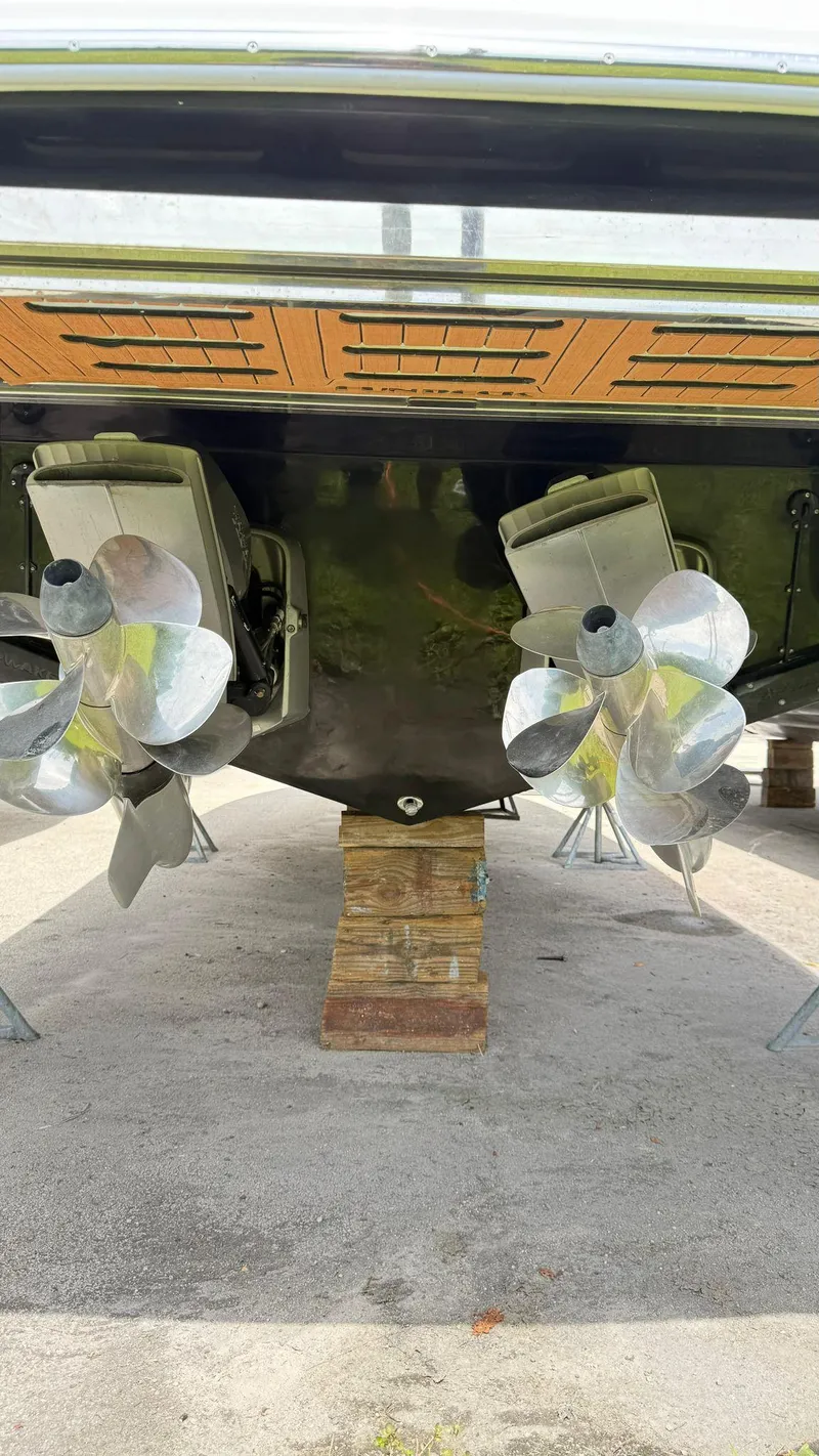 Slide: The Image of 2025 NX Boats NX370 HT propellers on dry dock, showcasing dual-engine setup. - 8