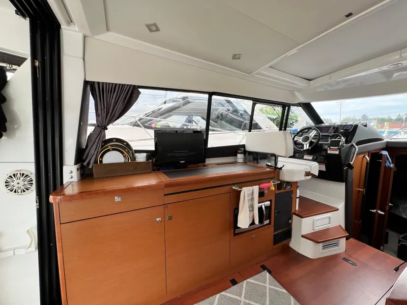 Slide: The Image of Interior of a 2017 Jeanneau NC11 yacht with wooden cabinetry and modern amenities. - 17