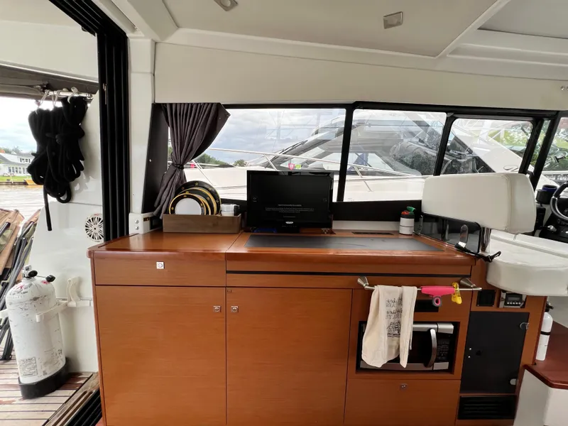 Slide: The Image of Electrical control panel on a 2017 Jeanneau NC11 boat, featuring battery breakers and generator controls. - 18