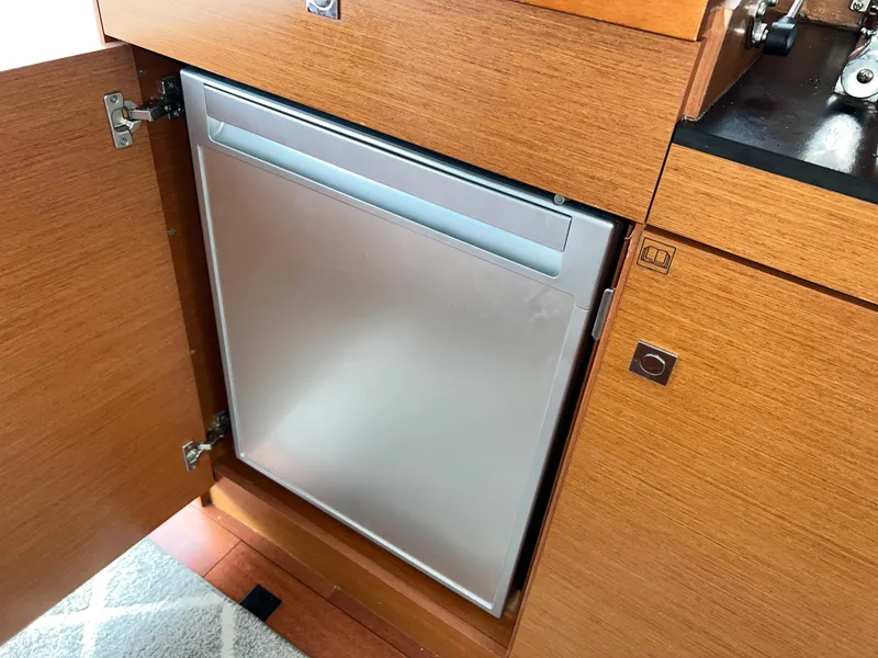 Slide: The Image of Built-in refrigerator in 2017 Jeanneau NC11 yacht's wooden cabinetry. - 19