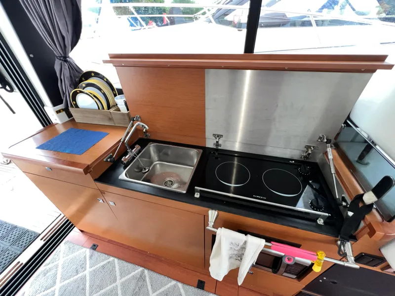 Slide: The Image of Interior view of 2017 Jeanneau NC11 boat cockpit with steering wheel and seating. - 23