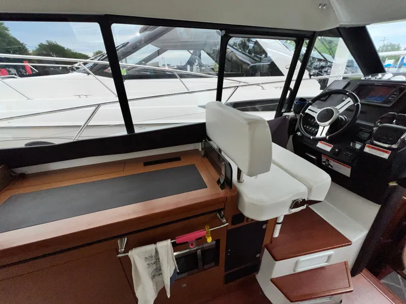 Slide: The Image of 2017 Jeanneau NC11 boat interior with modern helm and navigation equipment. - 25