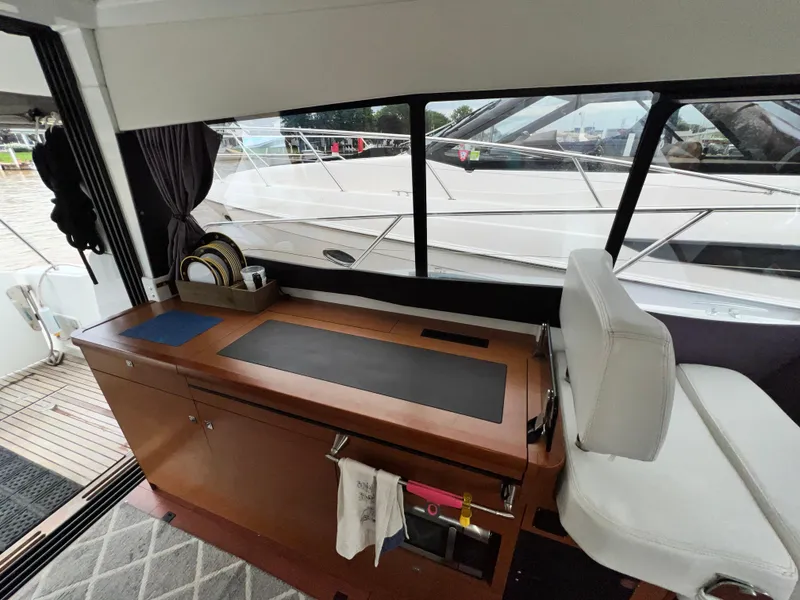 Slide: The Image of Interior view of 2017 Jeanneau NC11 boat cockpit with navigation equipment. - 26