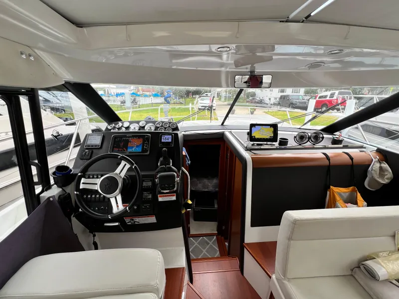 Slide: The Image of Interior of 2017 Jeanneau NC11 boat showing helm station and seating area. - 27