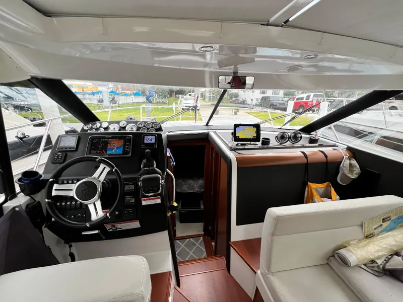 Slide: The Image of Interior view of 2017 Jeanneau NC11 boat cockpit with window and control panel. - 28