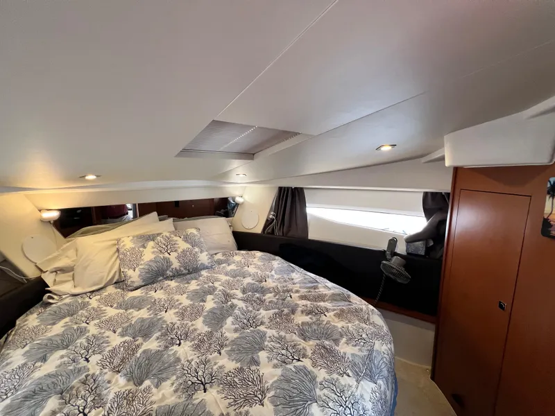 Slide: The Image of Closet interior on 2017 Jeanneau NC11 boat with hanging clothes and tropical wall art. - 42