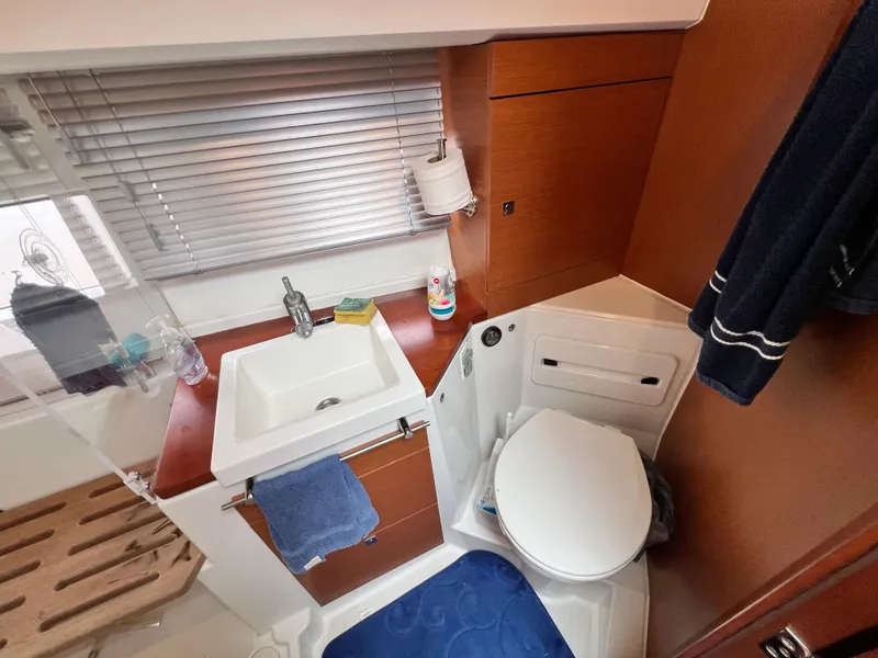 Slide: The Image of Engine room of 2017 Jeanneau NC11 with Cummins Onan generator and fluid containers. - 47