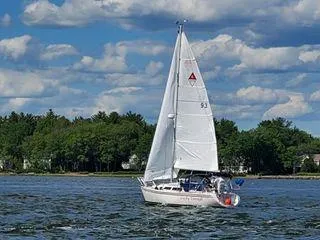 The Image of Sailboat Catalina 270 LE 1994 on a lake with trees and clouds in the background. - 0