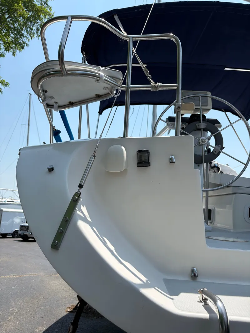 Slide: The Image of 1994 Catalina 270 LE sailboat stern with blue canopy and steering wheel. - 20
