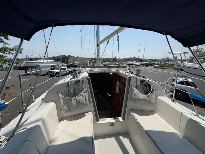 Slide: The Image of 1994 Catalina 270 LE sailboat cockpit with canopy, docked in a marina. - 22