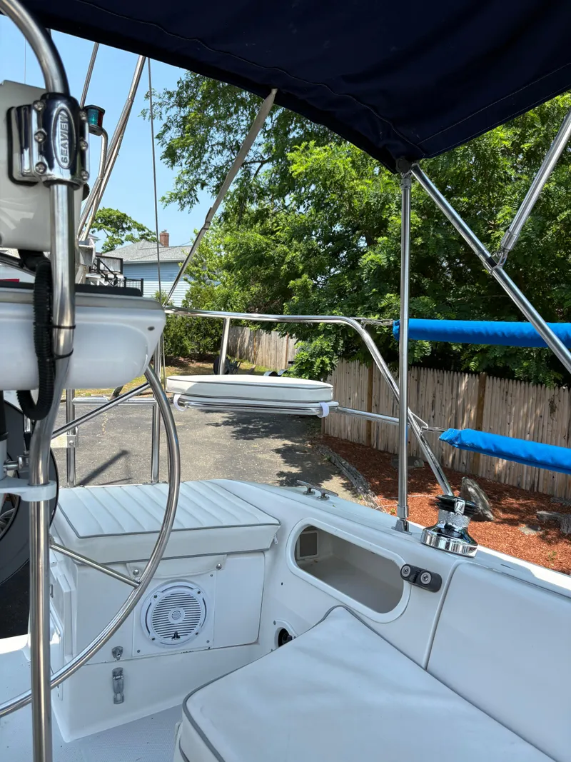 Slide: The Image of 1994 Catalina 270 LE sailboat cockpit with seating, steering wheel, and outdoor view. - 23