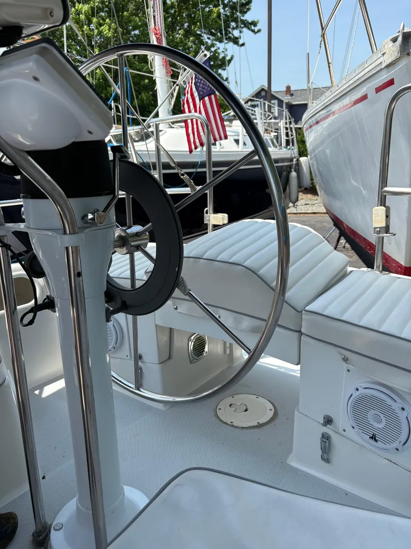 Slide: The Image of Interior view of a 1994 Catalina 270 LE sailboat with steering wheel and seating. - 24