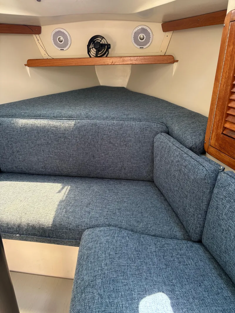 Slide: The Image of Cozy interior of 1994 Catalina 270 LE sailboat with blue upholstery and wooden accents. - 28