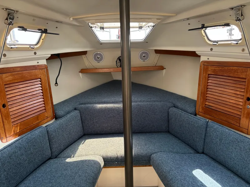 Slide: The Image of Interior of a 1994 Catalina 270 LE sailboat with blue cushions and wooden accents. - 30