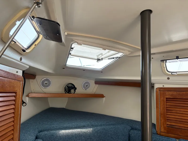 Slide: The Image of Interior of a 1994 Catalina 270 LE sailboat with cozy seating and wooden accents. - 32
