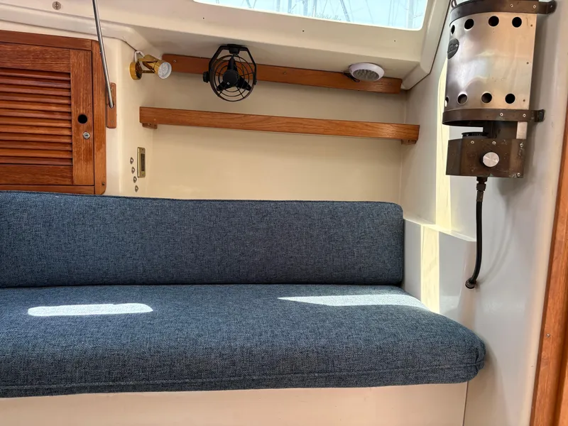 Slide: The Image of Interior of a 1994 Catalina 270 LE sailboat with blue cushioned seating. - 33