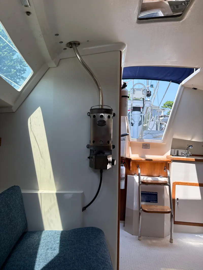 Slide: The Image of Interior of 1994 Catalina 270 LE sailboat, featuring seating and cabin entry. - 35