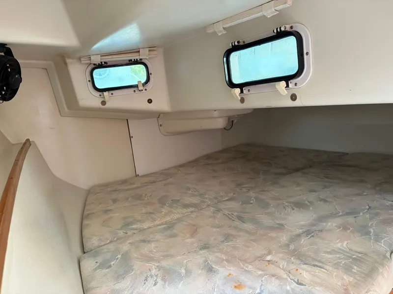 Slide: The Image of Interior cabin of a 1994 Catalina 270 LE sailboat with windows and bedding. - 39