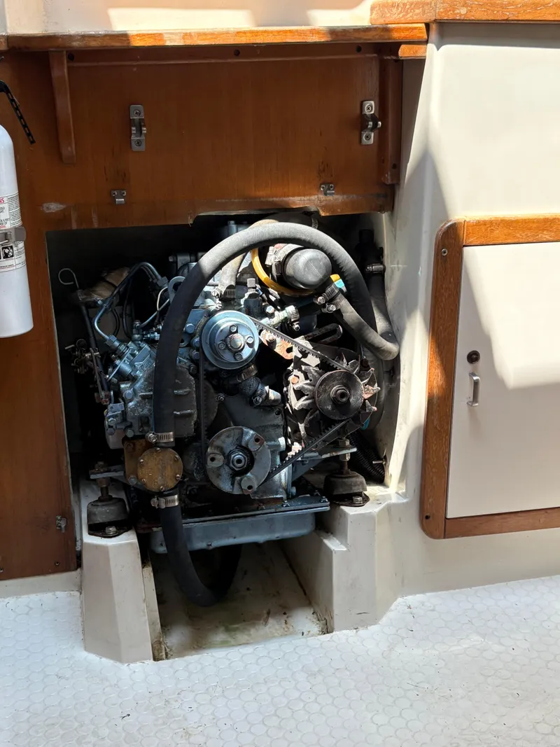 Slide: The Image of Engine compartment of a 1994 Catalina 270 LE sailboat, featuring visible mechanical components. - 43