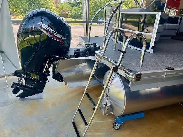 Slide: The Image of 2026 Barletta A20L pontoon boat with Mercury outboard motor and boarding ladder. - 1
