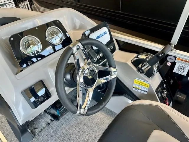 Slide: The Image of 2026 Barletta A20L boat dashboard with steering wheel and control panel. - 6