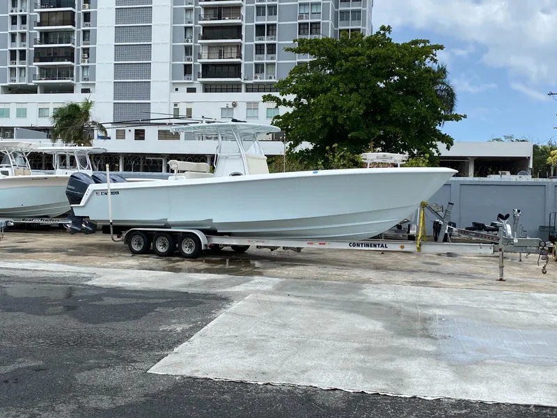 The Image of 2017 Contender 35 Tournament boat on trailer, parked near high-rise buildings. - 0
