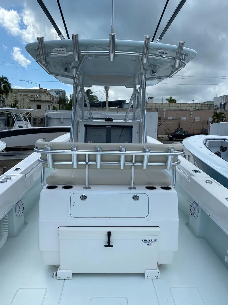 Slide: The Image of 2017 Contender 35 Tournament boat with center console and rod holders, docked under cloudy skies. - 11