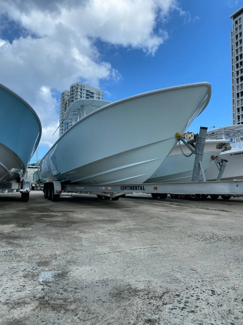 Slide: The Image of 2017 Contender 35 Tournament boat on trailer, under blue sky with clouds. - 4