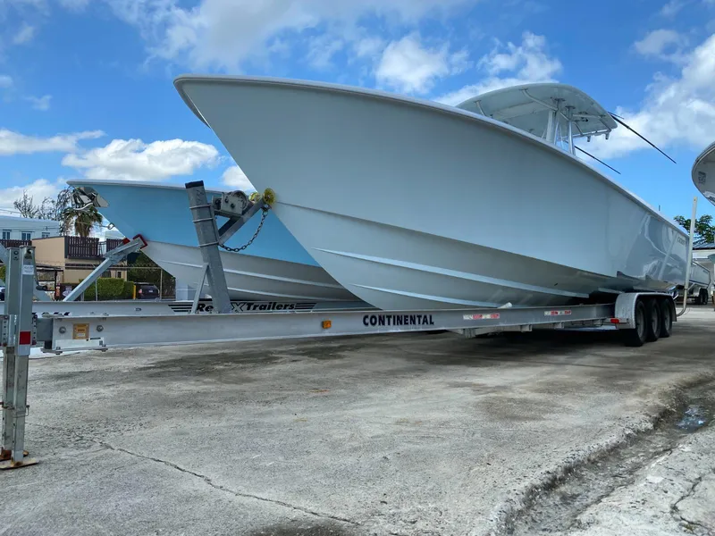 Slide: The Image of 2017 Contender 35 Tournament boat on trailer under blue sky. - 6