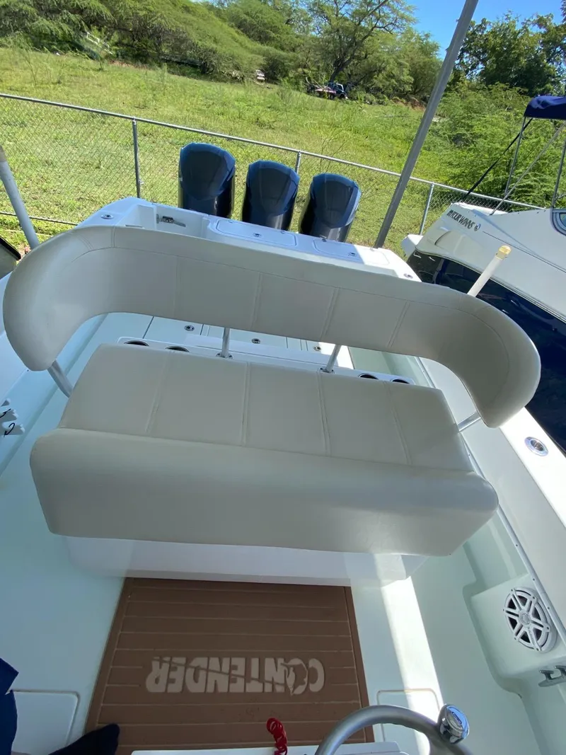 Slide: The Image of 2017 Contender 35 Tournament boat interior with seating and triple outboard engines. - 9