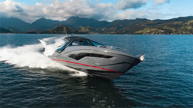 The Image of 2025 NX Boats NX44 PININFARINA cruising on a scenic lake with mountains. - 1