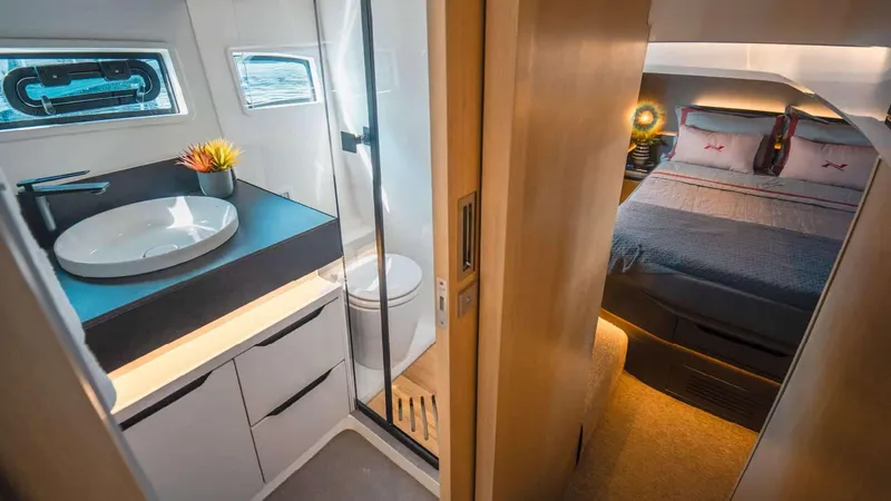 Slide: The Image of Luxurious interior of 2025 NX Boats NX44 PININFARINA, featuring a modern bathroom and cozy bedroom. - 13