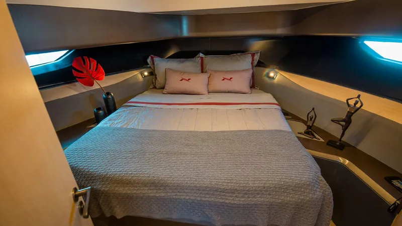 Slide: The Image of Luxurious bedroom interior of 2025 NX Boats NX44 PININFARINA yacht, featuring elegant decor and bedding. - 14